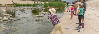 Boy learning how to fish at Atwater Park